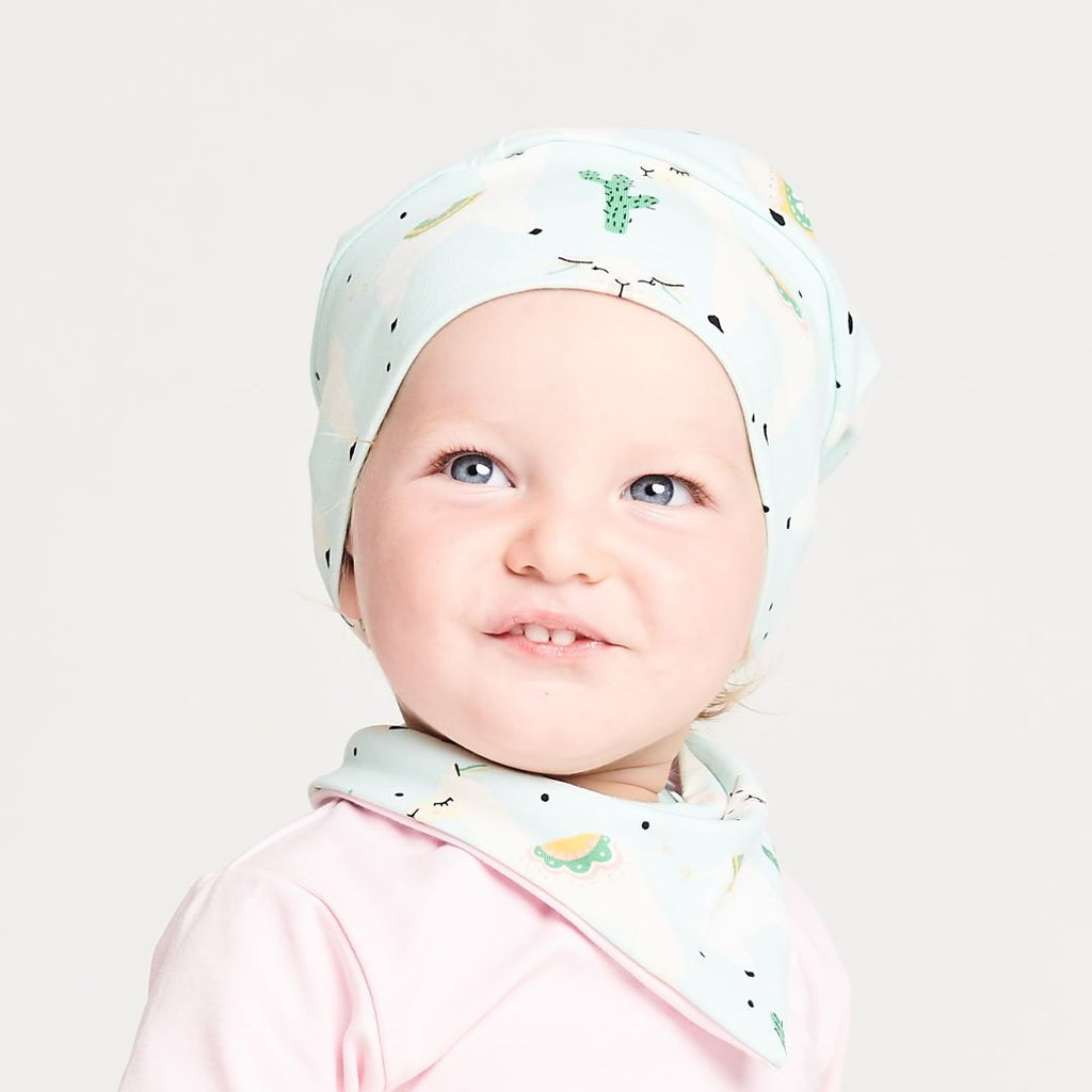 Lined baby hat "Alpakas Turquoise/Baby Pink"