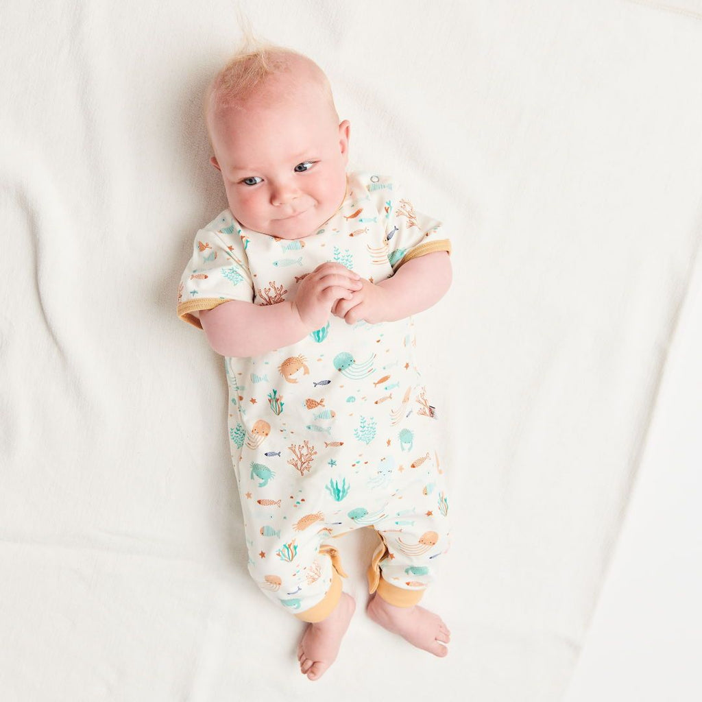 Organic shortsleeved romper "Ocean Party" made from 95% organic cotton and 5% elastane